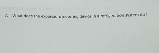 What does the expansion/metering device in a refrigeration system do?