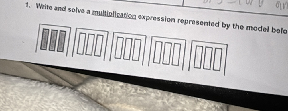 Write and solve a multiplication expression represented by the model belo