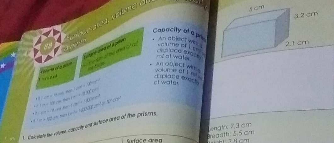 Capacity of ap
88
farfaçe area of a prisn
An object with 
displace exacty
mi of water.
k oloma ef a prsm ts m of the area of a volume of I sm 
the focks 
An object with 
volume of 1 m
displace exact

1=(abxA LEIV=100m^2
of water.
1 cm + 1 mn th m^2=18(80cm)
then
1/7=100cm then 1cm^3=1400mm^2 10°cm^,
cm=10m. / 1m+100° then Vm'=1000cm'. Calculate the volume, capacity and surface area of the prisms
ength: 7,3 cm
Breadth: 5,5 cm
Surface are gh 8 cm