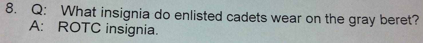 What insignia do enlisted cadets wear on the gray beret? 
A: ROTC insignia.