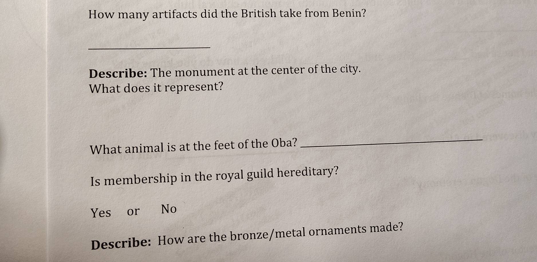 How many artifacts did the British take from Benin?
_
Describe: The monument at the center of the city.
What does it represent?
What animal is at the feet of the Oba?
_
Is membership in the royal guild hereditary?
Yes or No
Describe: How are the bronze/metal ornaments made?