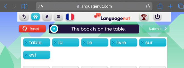 AA languagenut.com 
Languagenut 
Reset 2 The book is on the table. Submit 
table. la Le livre × sur 
× est