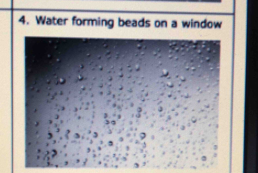 Water forming beads on a window