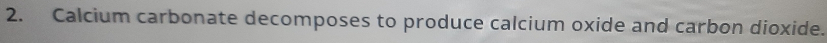 Calcium carbonate decomposes to produce calcium oxide and carbon dioxide.