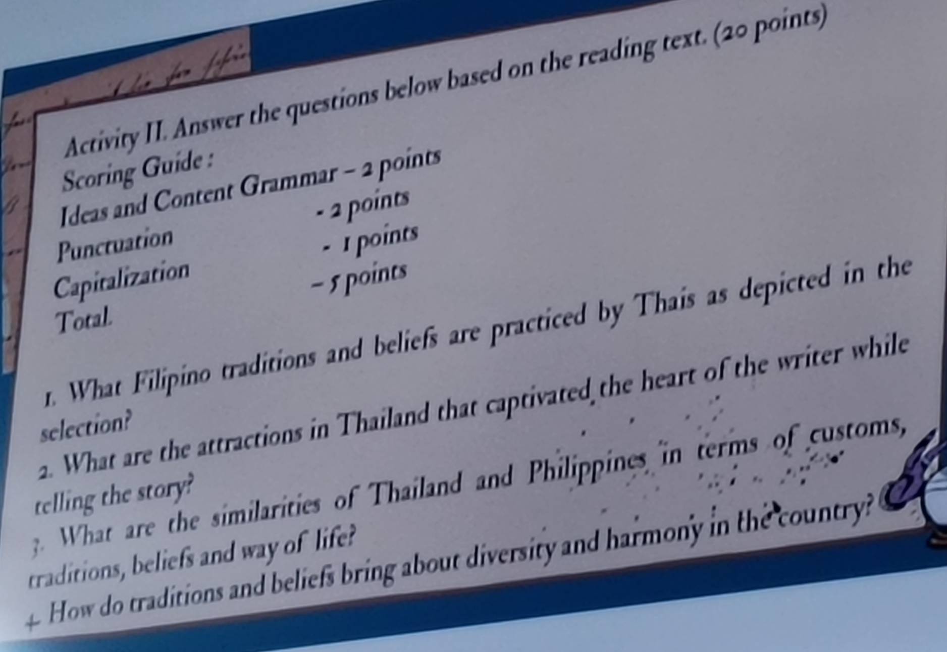 Activity II. Answer the questions below based on the reading text. (20 points) 
Scoring Guide : 
Ideas and Content Grammar - 2 points 
Punctuation - 2 points 
Capitalization - 1 points 
- 5 points 
Total 
r. What Filipino traditions and beliefs are practiced by Thais as depicted in the 
a. What are the attractions in Thailand that captivated the heart of the writer while 
selection? 
. What are the similarities of Thailand and Philippines in terms of customs, 
telling the story? 
traditions, beliefs and way of life? 
a How do traditions and beliefs bring about diversity and harmony in the country?