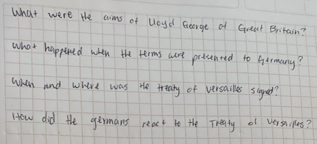 What were the aims of Uoud George of Great Britain? 
what happened when the terms are prevented to Germany? 
when and whire was the treaty of versailles signed? 
How did the germans react to the Treaty of versailles?