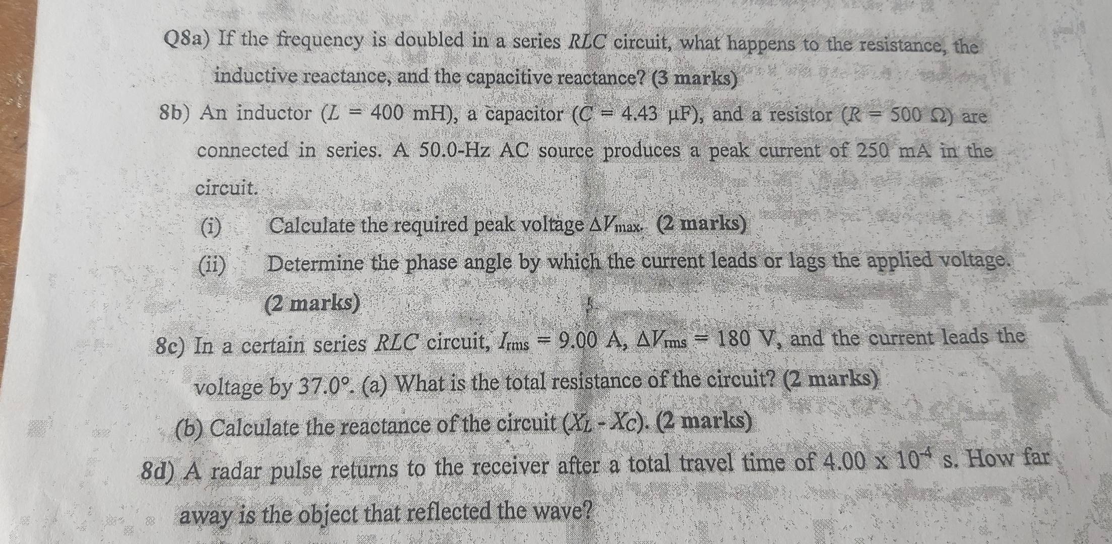 Q8a) If the frequency is doubled in a series RLC circuit, what happens to the resistance, the 
inductive reactance, and the capacitive reactance? (3 marks) 
8b) An inductor (L=400mH) , a capacitor (C=4.43mu F) , and a resistor (R=500Omega ) are 
connected in series. A 50.0-Hz AC source produces a peak current of 250 mA in the 
circuit. 
(i) Calculate the required peak voltage △ V_max. (2 marks) 
(ii) Determine the phase angle by which the current leads or lags the applied voltage. 
(2 marks) 
8c) In a certain series RLC circuit, I_rms=9.00A, △ V_rms=180V , and the current leads the 
voltage by 37.0° (a) What is the total resistance of the circuit? (2 marks) 
(b) Calculate the reactance of the circuit (X_L-X_C). (2 marks) 
8d) A radar pulse returns to the receiver after a total travel time of 4.00* 10^(-4)s. How far 
away is the object that reflected the wave?