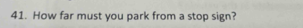How far must you park from a stop sign?
