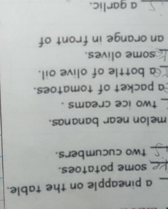 a pineapple on the table. 
_some potatoes. 
_ 
two cucumbers. 
melon near bananas. 
_two ice creams . 
a packet of tomatoes. 
_a bottle of olive oil. 
_ 
some olives. 
an orange in front of 
_a garlic.