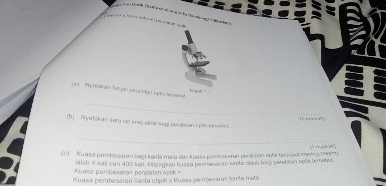 dhaya dan Optík (kanta cembung vs kanta cekung/ mikroskop) 
menunjukkan sebuah peralatan oplik 
(a) Nyatakan fungsi peralatan optik tersebut. 
Rajah 1.1 
_ 
[1 markah] 
(b) Nyatakan satu ciri imej akhir bagi peralatan optik tersebut. 
_ 
[1 markah] 
(c) Kuasa pembesaran bagi kanta mata dan kuasa pembesaran peralatan optik tersebut masing-masing 
ialah 4 kali dan 400 kali. Hitungkan kuasa pembesaran kanta objek bagi peralatan optik tersebut. 
Kuasa pembesaran peralatan optik = 
Kuasa pembesaran kanta objek x Kuasa pembesaran kanta mata