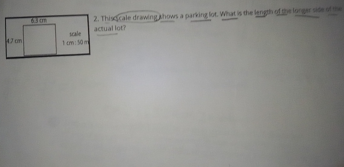 This scale drawing shows a parking lot. What is the length of the longer side of the 
actual lot?