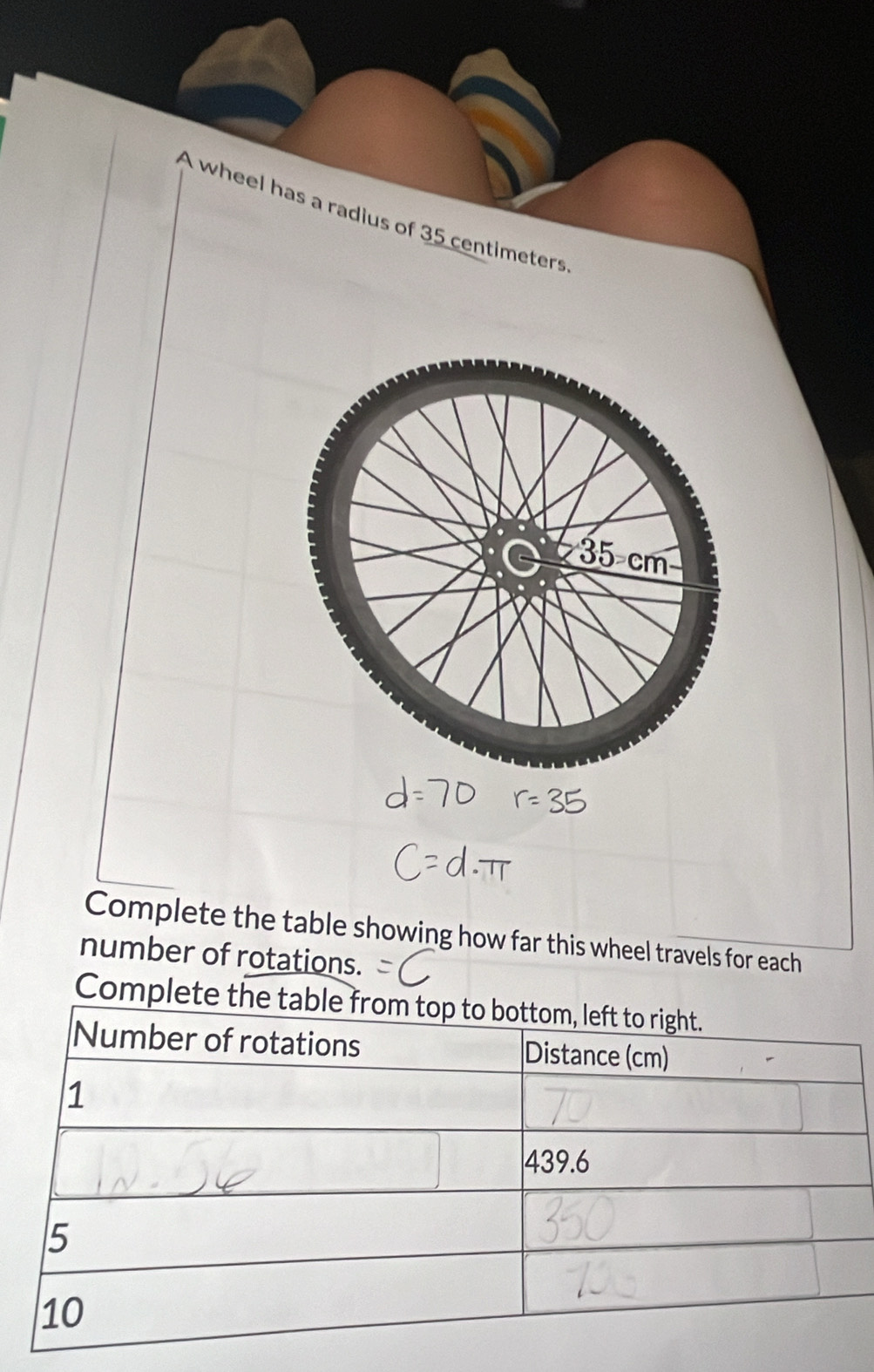 A wheel has a radius of 35 centimeters
Complete the table showing how far this wheel travels for each 
number of rotations. 
Complete