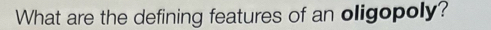 What are the defining features of an oligopoly?