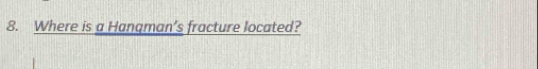 Where is a Hangman’s fracture located?