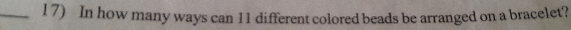 In how many ways can 11 different colored beads be arranged on a bracelet?