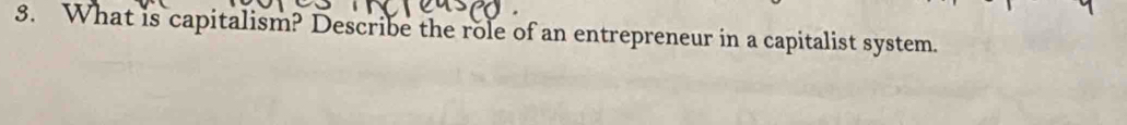 What is capitalism? Describe the role of an entrepreneur in a capitalist system.