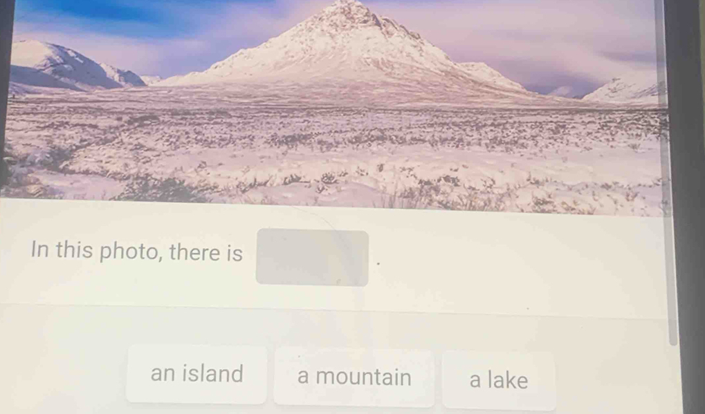 In this photo, there is
an island a mountain a lake