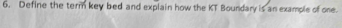 Define the term key bed and explain how the KT Boundary is an example of one.