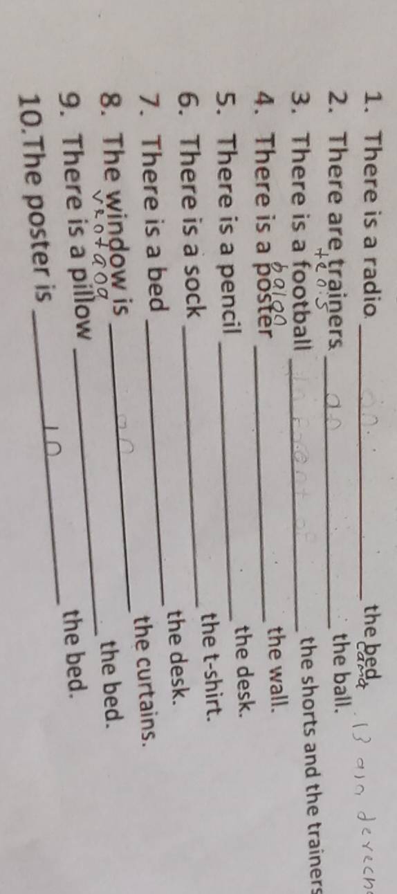 There is a radio _the bed 
2. There are trainers _the ball. 
3. There is a football_ 
the shorts and the trainers 
4. There is a poster _the wall. 
5. There is a pencil _the desk. 
6. There is a sock _the t-shirt. 
7. There is a bed _the desk. 
8. The window is _the curtains. 
9. There is a pillow _the bed. 
10.The poster is _the bed.