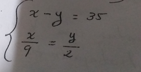 beginarrayl x-y=35  x/9 = y/2 endarray.