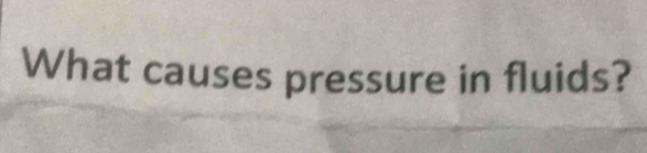 What causes pressure in fluids?