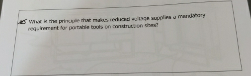 What is the principle that makes reduced voltage supplies a mandatory 
requirement for portable tools on construction sites?